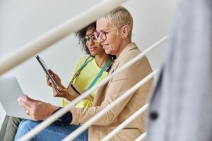 professional-women-collaborating-on-a-laptop